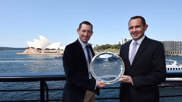 Jockey Hugh Bowman (left) and trainer Chris Waller admire the Cox Plate at Quay restaurant overlooking Sydney Harbour, on Monday. 
