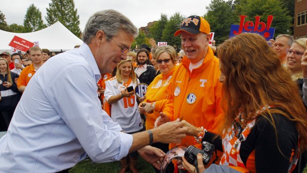 Republican presidential candidate Jeb Bush signs an autograph on the campaign trail in Tennessee.
