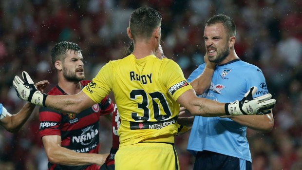 Flashpoint:  Matt Jurman of Sydney FC and Wanderers goalkeeper Liam Reddy share a moment of derby passion.