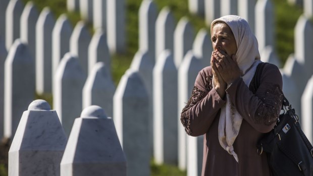A woman at the Potocari cemetery and memorial near Srebrenica in July 2015. More than 8000 Bosnian Muslim men and boys who had sought safe haven in Srebrenica were massacred by Bosnian Serb forces.