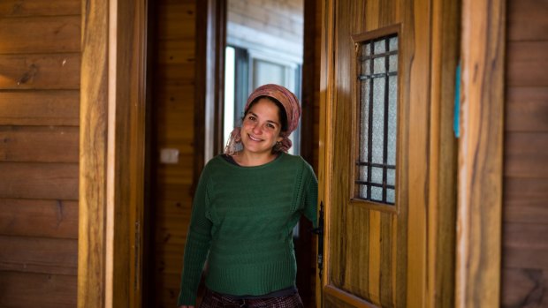Inbal Zeev, owner of 'Bikta Bakerem' bed and breakfast, which is advertised on Airbnb international home-sharing site and rental listings service, at the entrance to her property in the West Bank Jewish outpost of Esh Kodesh last week. 