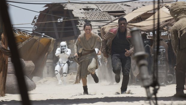 Hasty retreat ... Rey (Daisy Ridley) and Finn (John Boyega) in The Force Awakens.