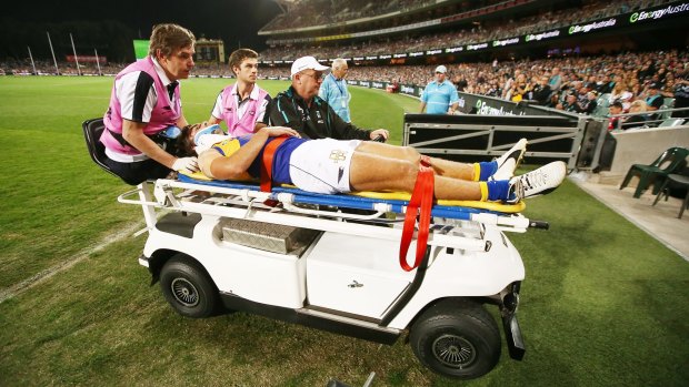 Andrew Gaff is taken from the field after the head high clash in round nine.