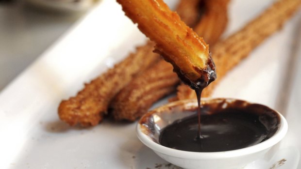 Churros with hot chocolate dipping sauce.