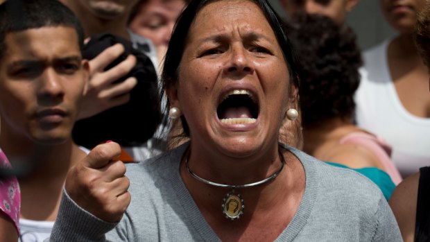 A woman shouts "Recall!" during a protest demanding food,  in Caracas on Thursday.