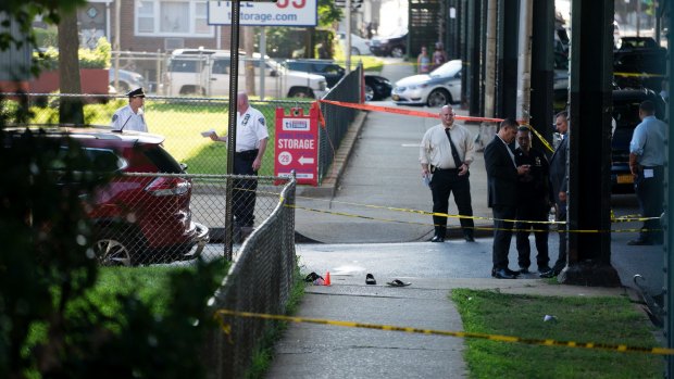 Sandals lay on a street corner at the crime scene where two men were shot dead. 