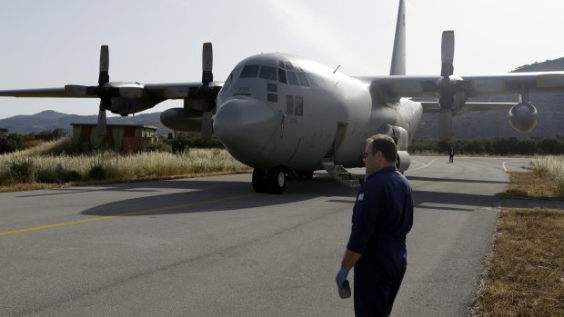 An engineer stands in front of a C-130 HAUP of the Hellenic Air Force, which took part in the searching operation of the missing EgyptAir plane.