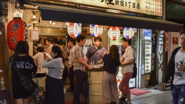 People having a drink in an izakaya, a Japanese style gastropub.