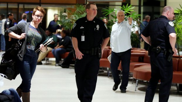 Officers guard the entrance to concourse A and B at the New Orleans International Airport following the incident. 