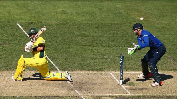 Australia's Aaron Finch sweeps strongly under clear skies at the MCG.