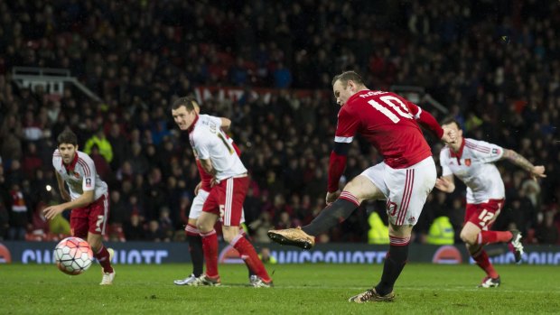 On target: Manchester United's Wayne Rooney scores a penalty during the English FA Cup third round match against Sheffield United at Old Trafford.