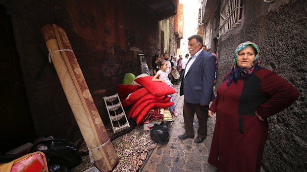 Residents stand by belongings they salvaged from their homes in  Diyarbakir.