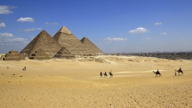 Gunmen on a speeding motorcycle opened fire outside the plateau of the famed Giza Pyramids on the outskirts of Cairo early on Wednesday, killing two policemen.