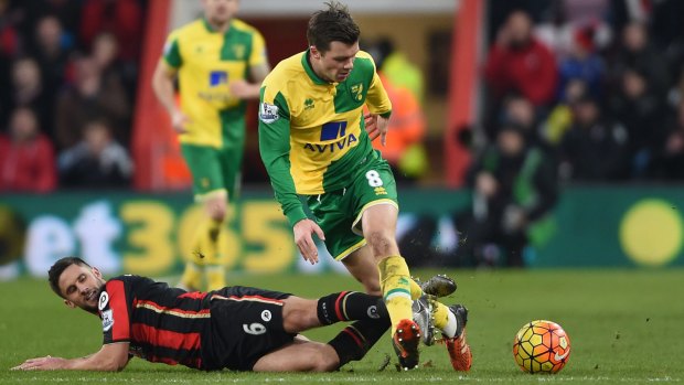 Sliding in: Bournemouth's Andrew Surman and Norwich City's Jonny Howson battle for the ball.
