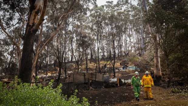 Firefighters inspect the damage caused by the Otways fire.