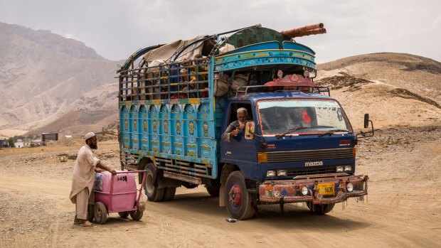 In a photo provided by the Norwegian Refugee Council, a truck carries an ousted Afghan family back to their country from Pakistan, near Torkham, Afghanistan. 