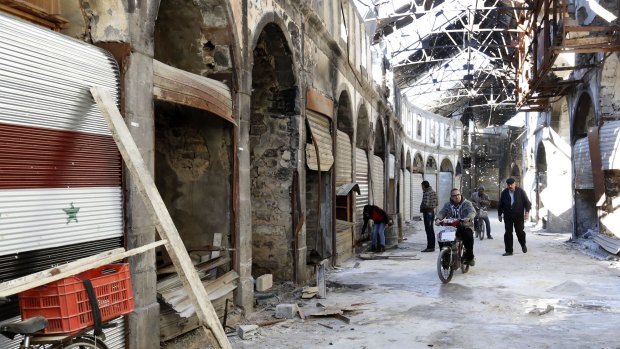 Repair work begins in Homs, Syria, on Tuesday.
