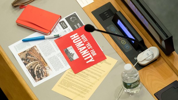 Leaflets are seen on a UN delegate's desk before a vote on the treaty to ban nuclear weapons.