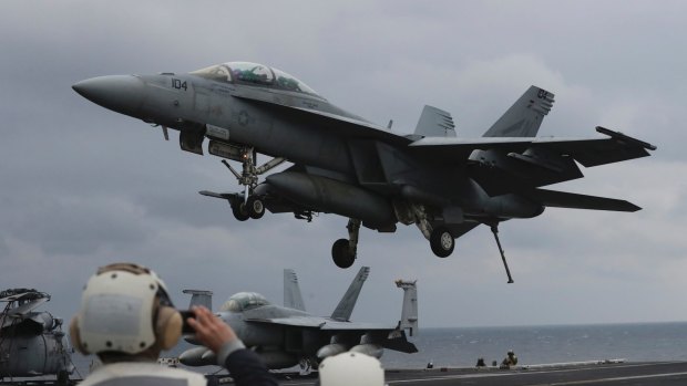 A US Navy F/A-18 Super Hornet fighter approaches the deck of the USS Carl Vinson, whose diversion towards the Korean peninsular has provoked Pyongyang.