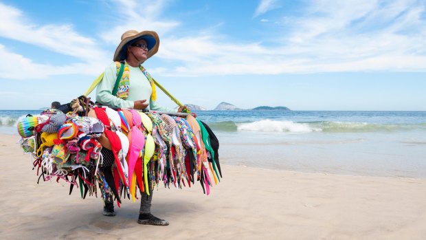 A beach vendor sells bikinis on Ipanema Beach.
