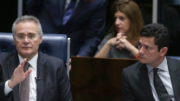 Brazil's Senate President Renan Calheiros, left, and Brazilian Federal Judge Sergio Moro, who is leading the Petrobras corruption attend a Senate session in Brasilia on Thursday.