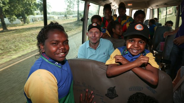 Prime Minister Tony Abbott joins the Remote School Attendance Strategy bus to pick up school children for school in Bamaga, during his visit to Cape York on Wednesday.