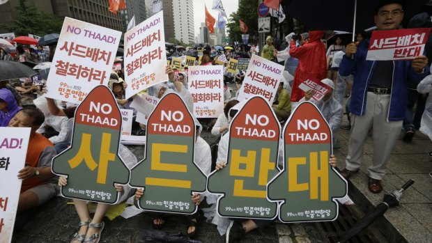 South Korean protesters stage a rally to oppose the deployment of the Terminal High-Altitude Area Defence on Saturday. Signs read: "Oppose the deployment of the THAAD". 