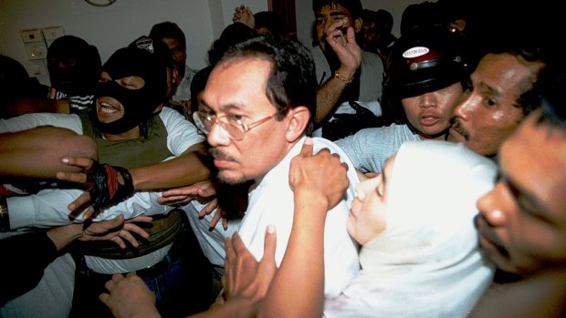Former deputy prime minister Anwar Ibrahimwhen being escorted from his home in 1998.