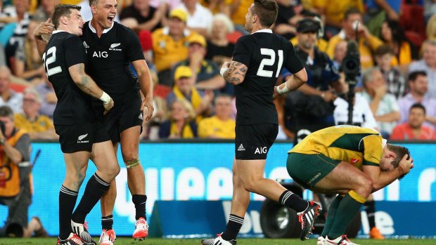 Dark day: Bernard Foley slumps to his knees as the All Blacks steal the match in Brisbane.