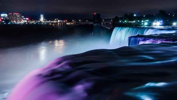 ILLUMINATIONS, NIAGARA FALLS, CANADA. As darkness falls, Niagara Falls glows with multiple colours projected onto the waterfalls to spectacular effect. If you're here on special occasions, the colours will match: green for St Patrick's Day, red and white for Canada Day. 