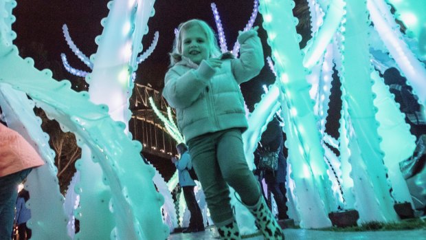 Three-year-old Liddia Vlahos, runs through the lighting installations at on the opening night of Vivid in Sydney. 