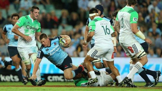 Going to ground: Paddy Ryan is brought down during the Waratahs' loss to the Highlanders.