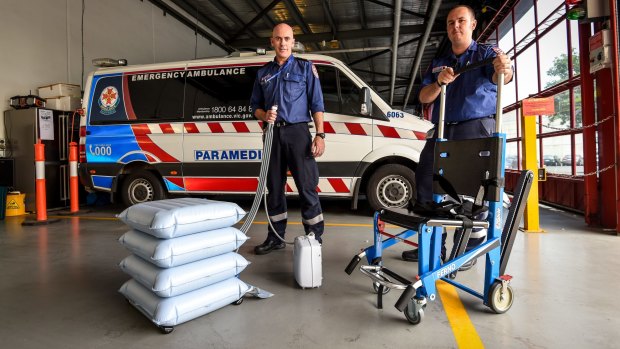 The Age, News 4/11/2015. photo by Justin McManus. Ambulances are using new technology to help transfer obese patients into ambulances.  Jerome Peyton and David Shearer with the devices.