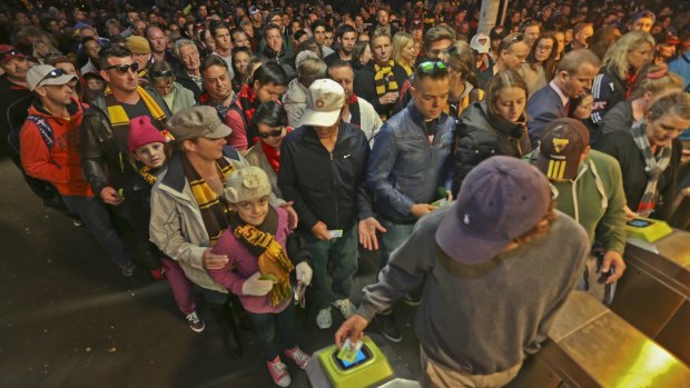 Crowds of people line up at Richmond station as fans are forced to swipe their myki cards.