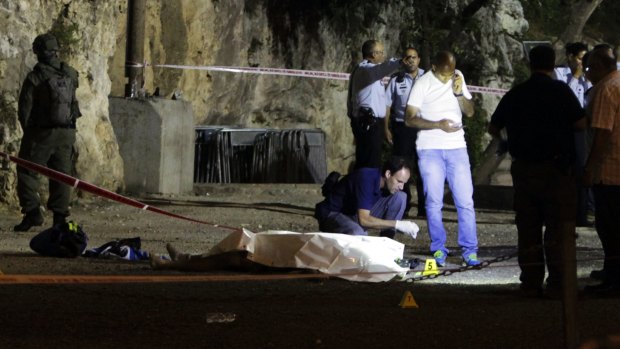 Israeli police stand around a body of a Palestinian after the attack in Jerusalem's occupied Old City on Friday.