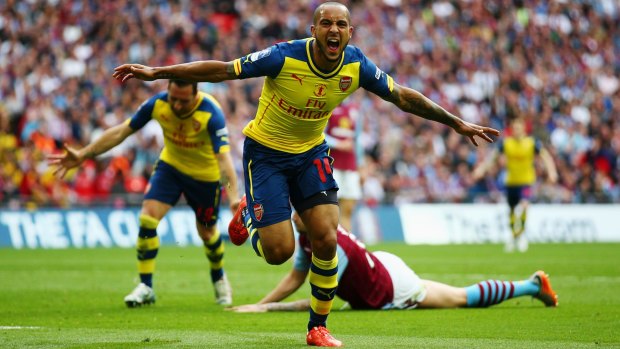 Theo Walcott celebrates scoring the first goal for Arsenal during the FA Cup final against Aston Villa at Wembley on Saturday. 