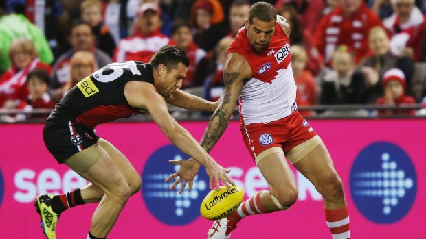 Vying for possesion: Lance Franklin fails to pick up the ball on the run from Sam Fisher during the Swans' clash with the Saints.