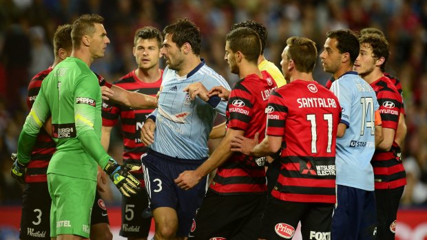Sasa Ognenovski of Sydney FC scuffles with Wanderers players. 