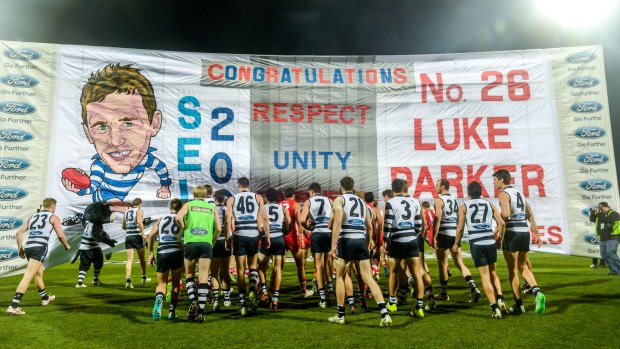 Show of unity: Geelong and Sydney run through the same banner at Simmonds Stadium.