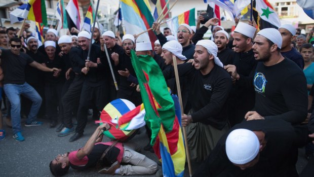 Druze men in the Israeli-occupied Golan Heights town of Majdal Shams demonstrate in support of the Syrian regime.
