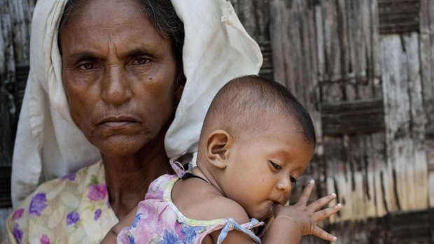 A Rohingya Muslim woman and baby at a camp set up outside the city of Sittwe in Myanmar's Rakhine state. 