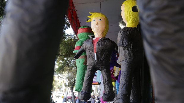 Pinatas in the likeness of Donald Trump hang for sale outside a Mission District discount store in San Francisco, California. 