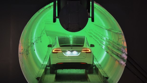A modified Tesla Model X drives into the tunnel entrance before an unveiling event for the Boring Company Hawthorne test tunnel in Hawthorne, south of Los Angeles.