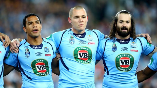 Brothers in arms: David Klemmer and Aaron Woods sing the national anthem with Will Hopoate before game one of the 2015 State of Origin series.