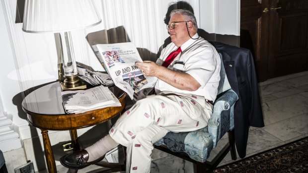 An attendee reads a newspaper before a campaign event with Donald Trump in Philadelphia.