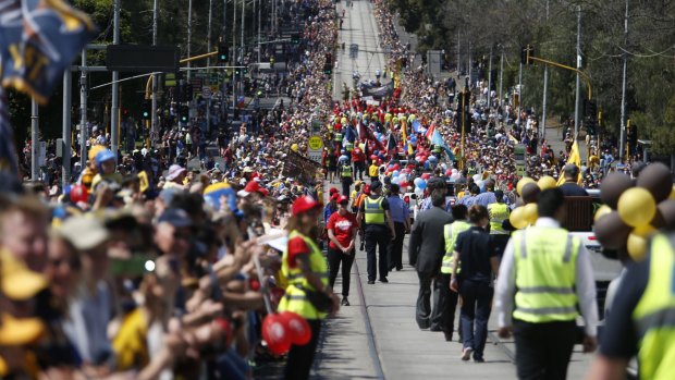 Thousands crammed the grand final parade route, thanks to the public holiday and the good weather.