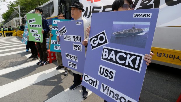 South Koreans stage a rally against deployment of the aircraft carrier USS Carl Vinson.