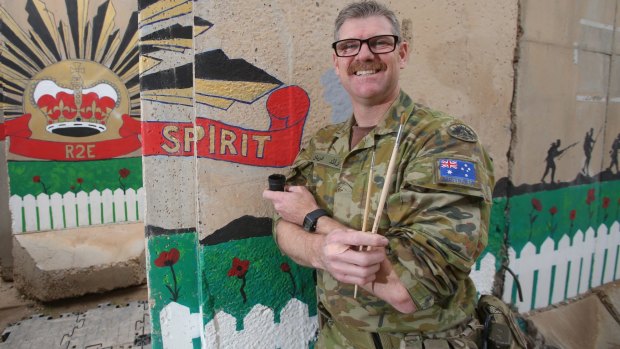 Major Adrian Sweatman, of Brisbane, has continued working on  the Anzac mural that was started by the first contingent at Camp Sosi, in Iraq.