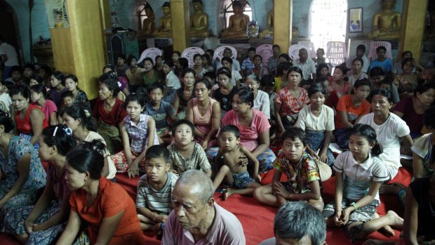 Flood victims gather inside a monastery, opened as a temporary relief camp, in Myauk U, Myanmar.
