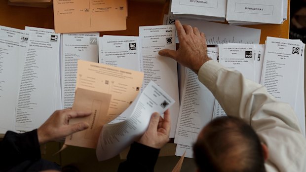 Spanish voters  collect their ballot papers at a polling station in Madrid on Sunday.